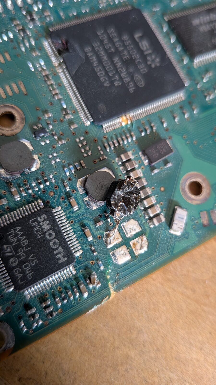 Macro shot of the crushed component next to the LSI controller&rsquo;s bent, torn corner pins